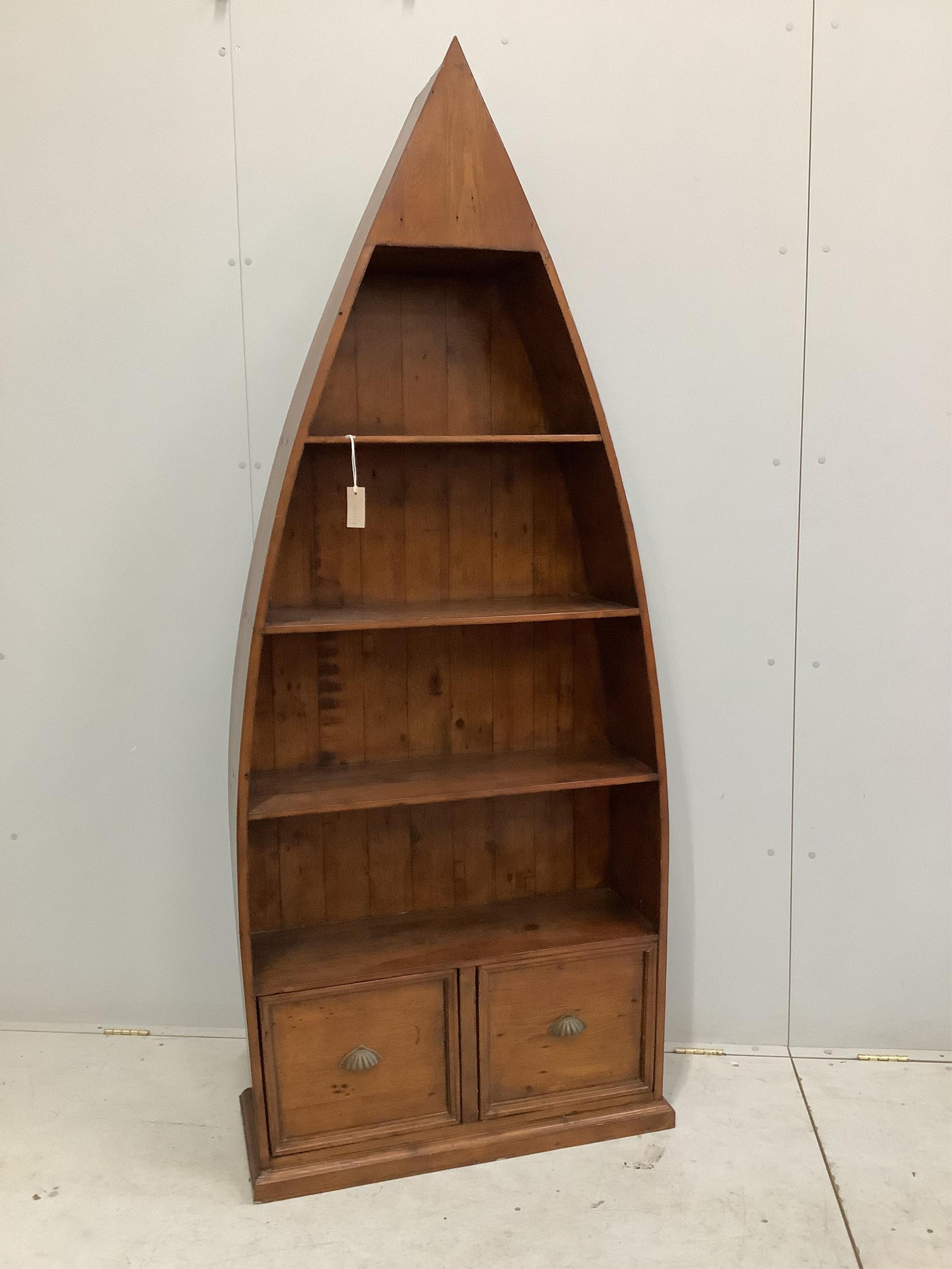 A reproduction Barker and Stonehouse hardwood boat shaped two drawer bookcase, width 83cm, depth 32cm, height 204cm. Condition - fair to good